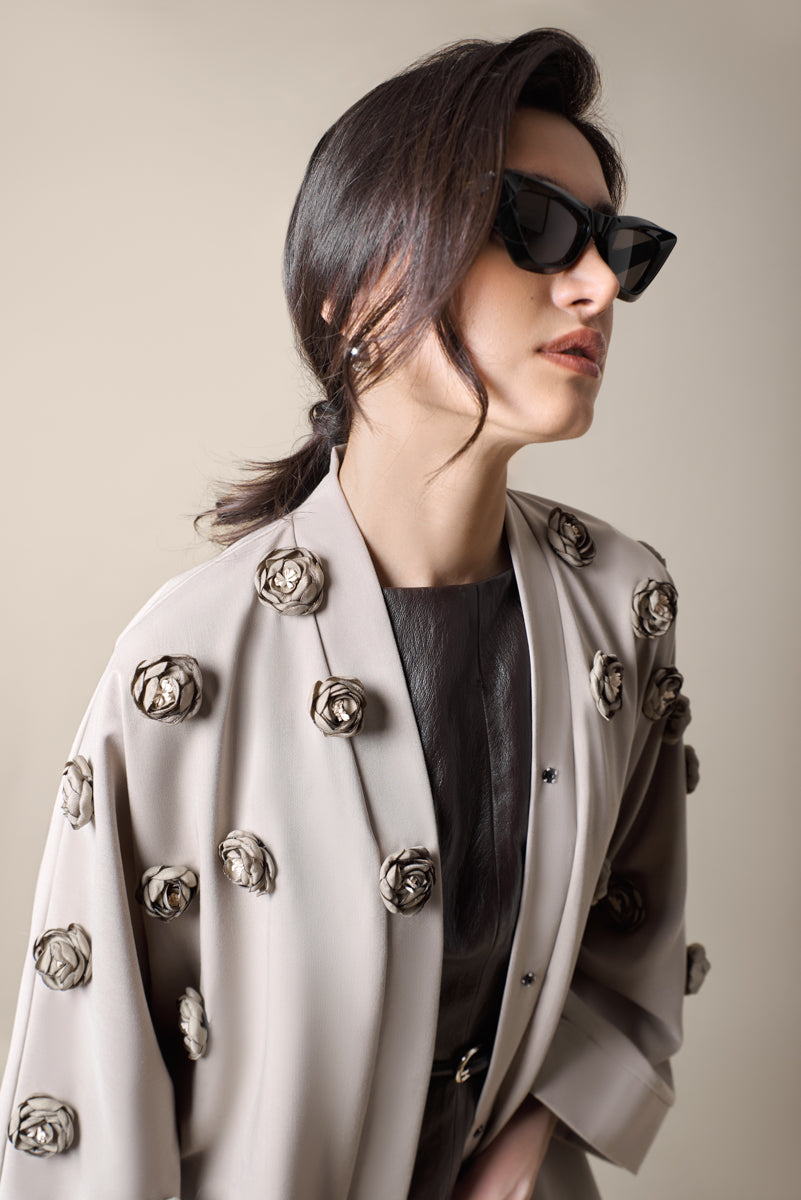 Taupe abaya with 3D flowers around chest close-up details