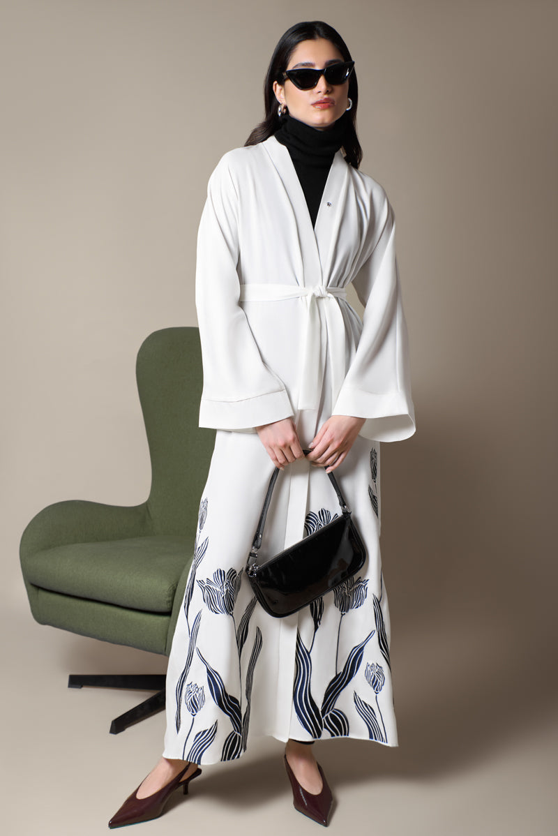 Off-white abaya with navy embroidered floral details and matching belt