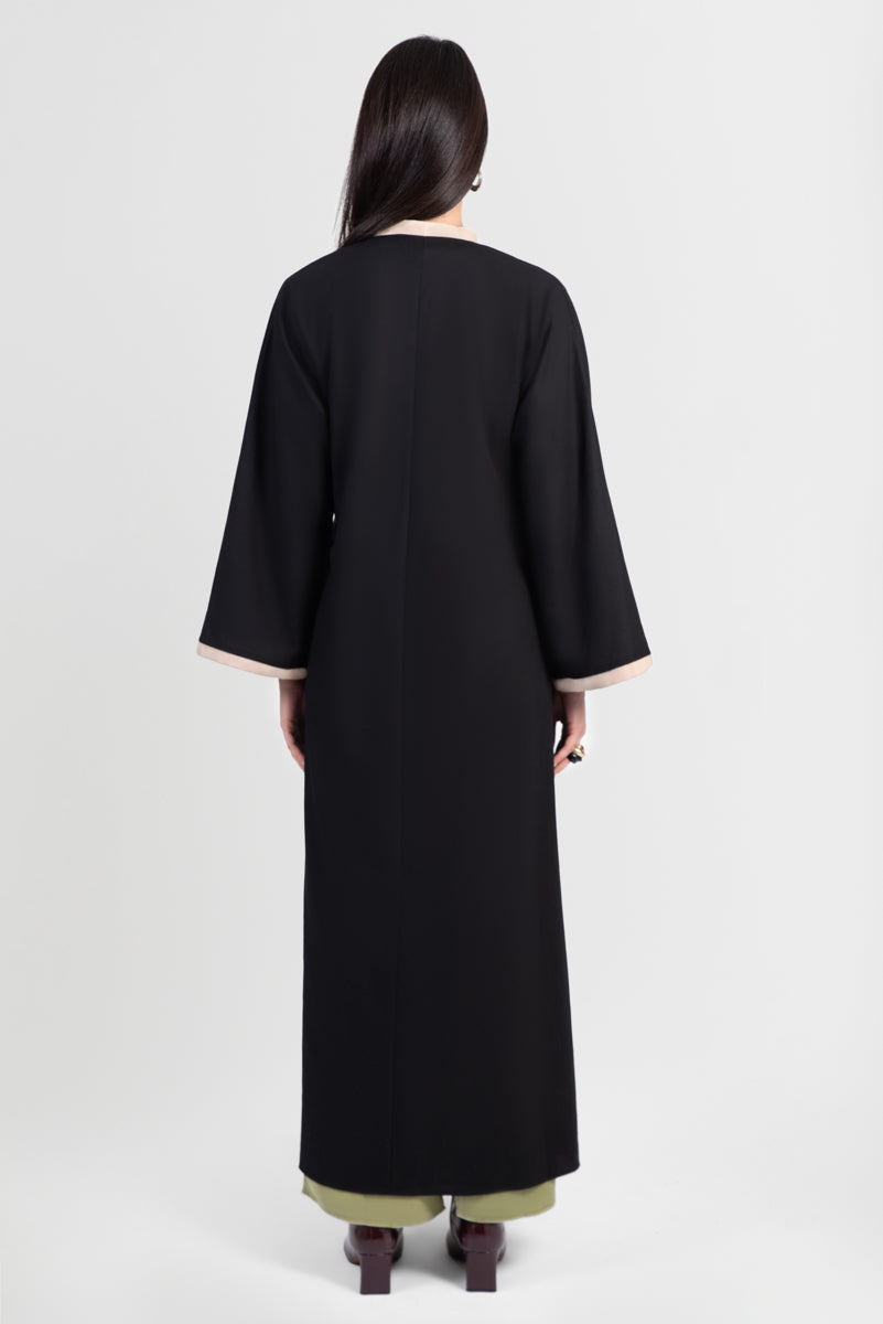 Black linen cotton kimono-style abaya with off-white trim along edges and matching belt back view