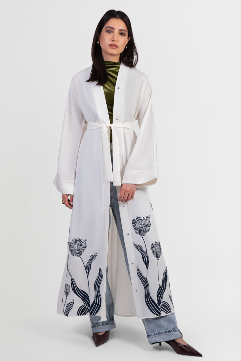 Off-white abaya with navy embroidered floral details and matching belt