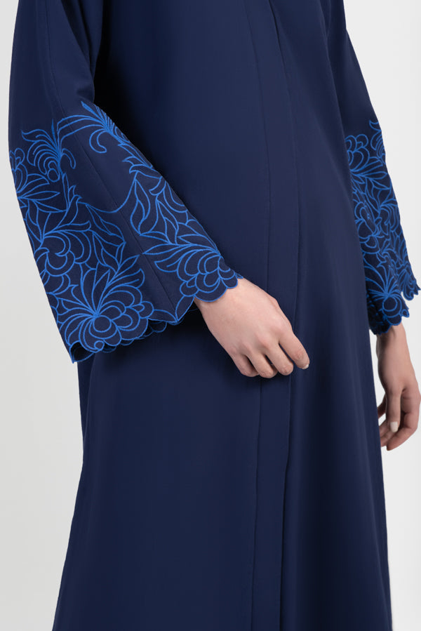Navy cotton abaya with light blue embroidered floral design around sleeves details