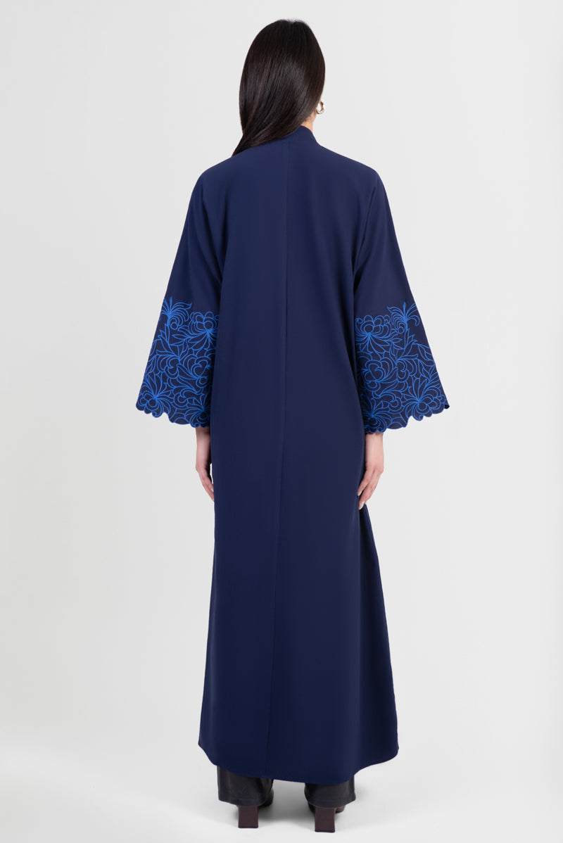 Navy cotton abaya with light blue embroidered floral design around sleeves back view
