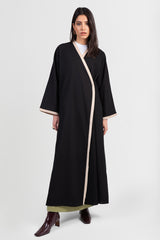 Black linen cotton kimono-style abaya with off-white trim along edges and matching belt front view