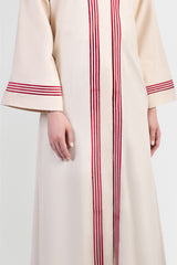 Beige linen abaya with red stripes running vertically around front placket and sleeve cuffs details