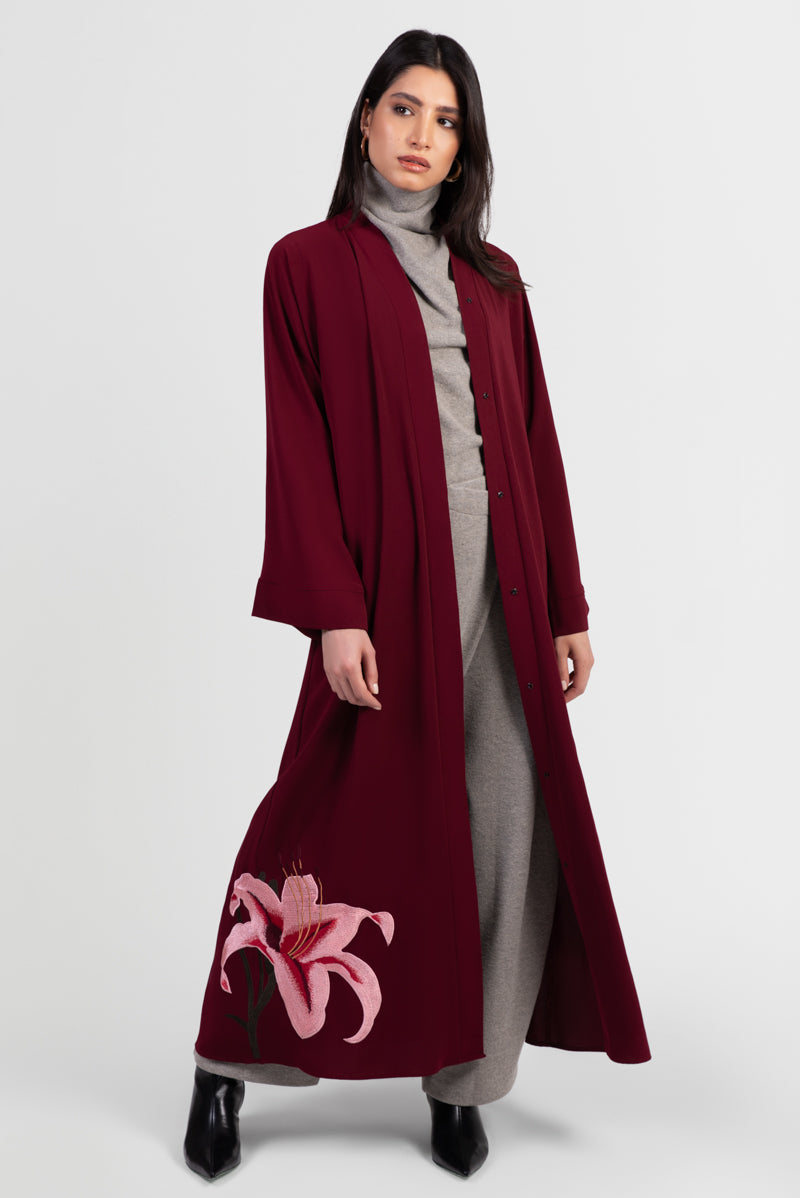 Burgundy abaya with pink lily embroidery around bottom hemline open front
