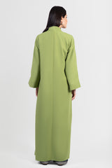 Moss green abaya with black embroidery and bright green outline, back view