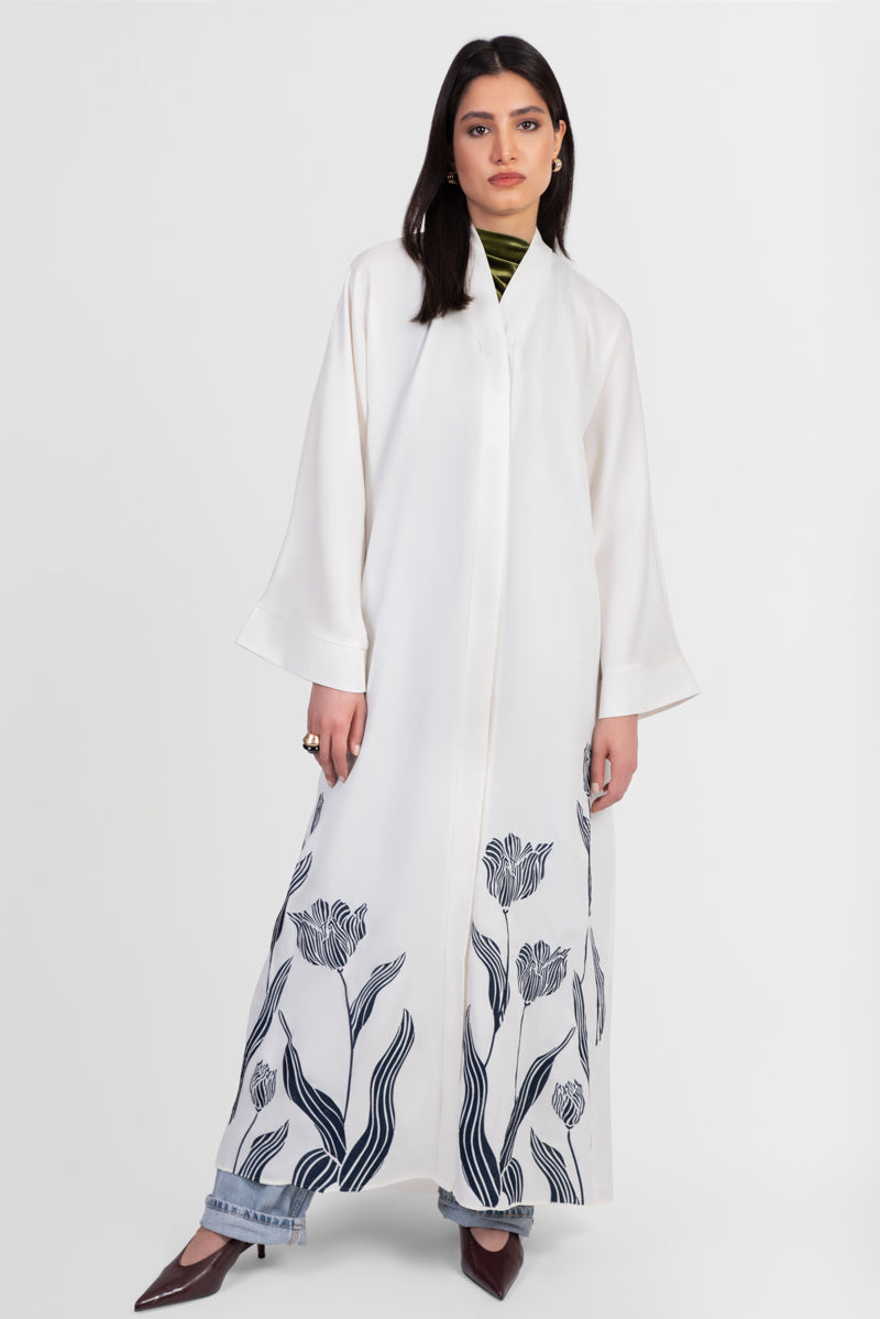 Off-white abaya with navy embroidered floral details front view