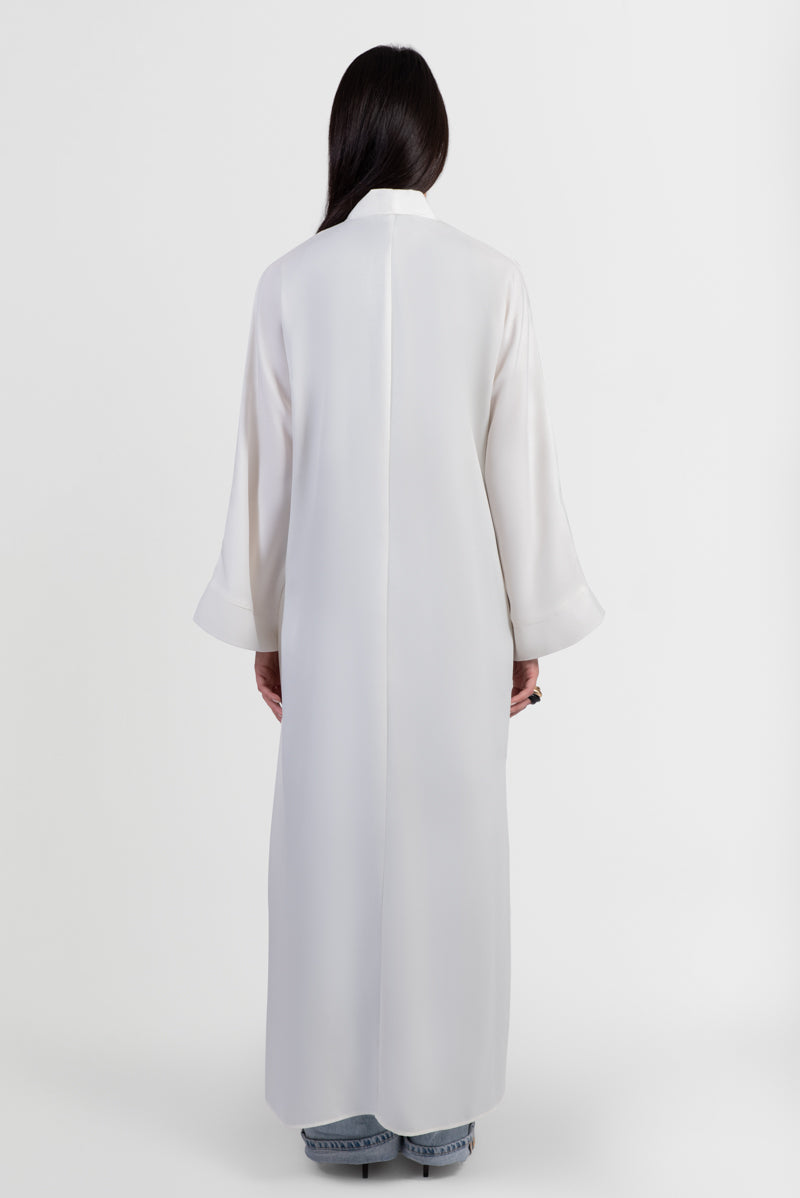 Off-white abaya with navy embroidered floral details back view