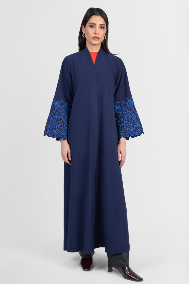 Navy cotton abaya with light blue embroidered floral design around sleeves front view