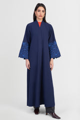 Navy cotton abaya with light blue embroidered floral design around sleeves front view