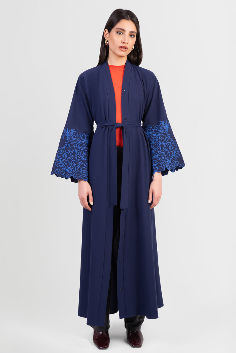 Navy cotton abaya with light blue embroidered floral design around sleeves and matching belt front view