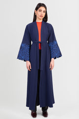 Navy cotton abaya with light blue embroidered floral design around sleeves and matching belt front view